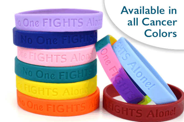 No One Fights Alone wristband group picture showing a variety of the silicone wristband colors that are embossed with the No One Fights Alone® slogan.