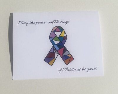 "may the peace and blessings of Christmas be yours" card wit a stained glass multicolored cancer ribbon