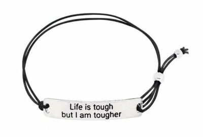 black bracelet with silver charm with text reading "Life is tough but I am tougher"