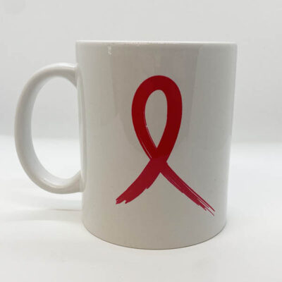 white coffee mug with red painted ribbon in the center