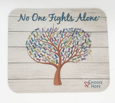 white wood printed mousepad with a tree in the center, the leaves being different colored cancer ribbons, on top has blue cursive text reading "No One Fights Alone"