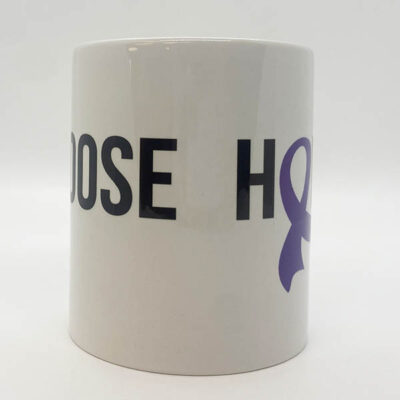 white coffee mug with bold black text with a dark blue ribbon as an O