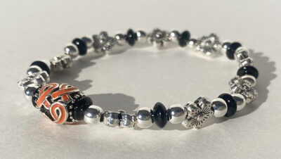 floral metal bracelet with orange cancer ribbon charm in the middle