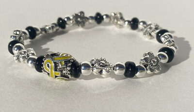 floral metal bracelet with yellow cancer ribbon charm in the middle