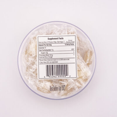 Image showing Queasy Drops in Ginger flavor. These come in a container with 21 lozenges in each container, this image is showing the bottom side of the container with the ingredients and nutrition facts label.
