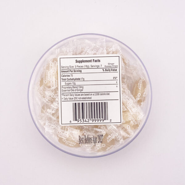 Image showing Queasy Drops in Ginger flavor. These come in a container with 21 lozenges in each container, this image is showing the bottom side of the container with the ingredients and nutrition facts label.