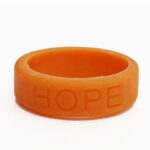 Silicone HOPE ring in Amber color with the word "HOPE" debossed on the ring.