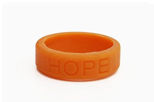 Silicone HOPE ring in Amber color with the word "HOPE" debossed on the ring.