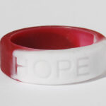 Silicone HOPE ring in Burgundy/White color with the word "HOPE" debossed on the ring.