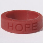 Silicone HOPE ring in Burgundy color with the word "HOPE" debossed on the ring.