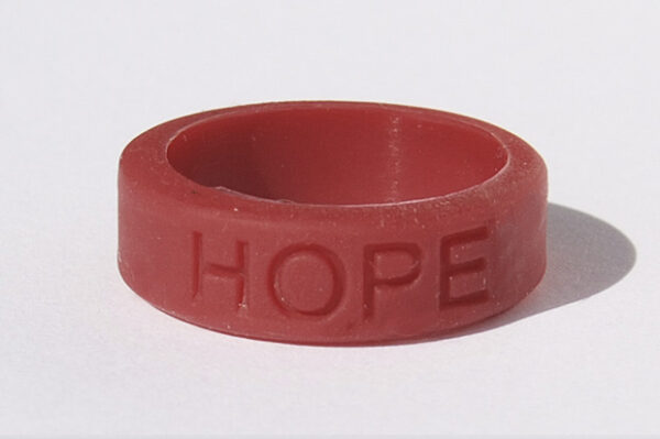 Silicone HOPE ring in Burgundy color with the word "HOPE" debossed on the ring.