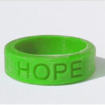 Silicone HOPE ring in Kelly Green color with the word "HOPE" debossed on the ring.