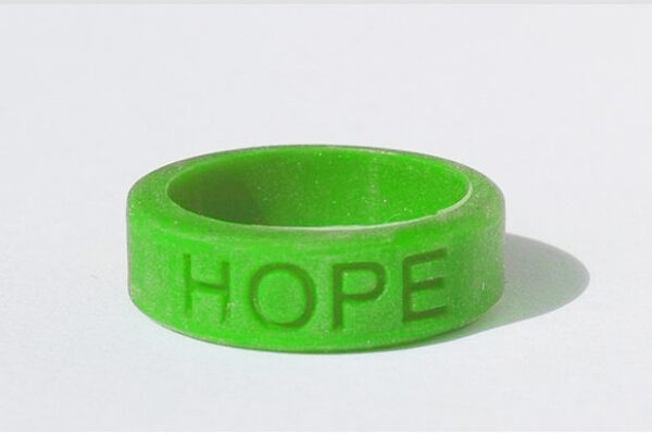 Silicone HOPE ring in Kelly Green color with the word "HOPE" debossed on the ring.