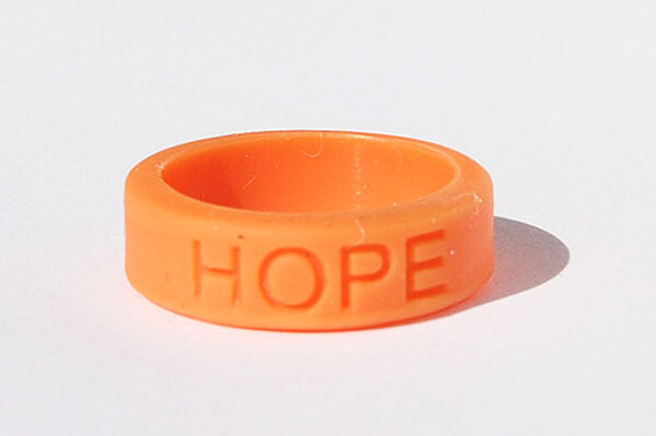 Silicone HOPE ring in Orange color with the word "HOPE" debossed on the ring.