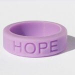 Silicone HOPE ring in Orchid color with the word "HOPE" debossed on the ring.