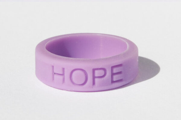 Silicone HOPE ring in Orchid color with the word "HOPE" debossed on the ring.