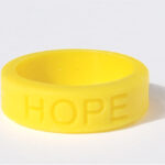 Silicone HOPE ring in Yellow color with the word "HOPE" debossed on the ring.