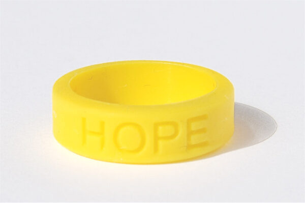Silicone HOPE ring in Yellow color with the word "HOPE" debossed on the ring.
