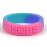 Silicone HOPE ring in Teal, Pink and Blue color with the word "HOPE" debossed on the ring.