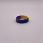 Silicone HOPE ring in Marigold/Blue/Purple color with the word "HOPE" debossed on the ring.