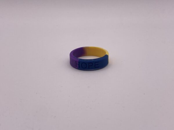 Silicone HOPE ring in Marigold/Blue/Purple color with the word "HOPE" debossed on the ring.