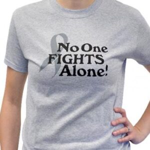 Group image showing our No One Fights Alone® T-shirt that has the wording "No One Fights Alone!" and a cancer awareness ribbon printed on the front of the t-shirt which is a light heather grey color.