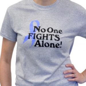 Group image showing our No One Fights Alone® T-shirt that has the wording "No One Fights Alone!" and a cancer awareness ribbon printed on the front of the t-shirt which is a light heather grey color.