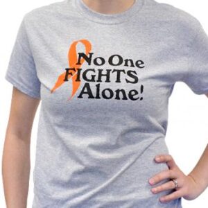 Group image showing our No One Fights Alone® T-shirt that has the wording "No One Fights Alone!" and a cancer awareness ribbon printed on the front of the t-shirt which is a light heather grey color.
