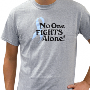 Group image showing our No One Fights Alone® T-shirt that has the wording "No One Fights Alone!" and a cancer awareness ribbon printed on the front of the t-shirt which is a light heather grey color.
