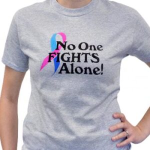 Group image showing our No One Fights Alone® T-shirt that has the wording "No One Fights Alone!" and a cancer awareness ribbon printed on the front of the t-shirt which is a light heather grey color.