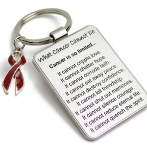 Group Image showing our What Cancer Cannot Do® Keychain with Ribbon Charm which a metal dog tag keychain that has the "What Cancer Cannot Do®" Poem laser engraved onto the keychain, with a cancer awareness ribbon charm in the color of your choice hooked onto the key ring of the keychain.