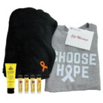 Group Image of our Cozy Blanket Gift Set featuring 1 blanket with orange cancer awareness ribbon 4 naked bee lip balm 1 naked bee lotion and 1 Choose Hope Crewneck Sweatshirt