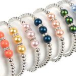 Image shows one of our cancer awareness bracelet options in a variety of colors - this is the 'pearls of hope bracelet'